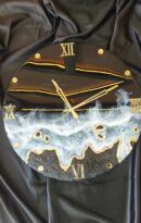 Handmade black and gold resin wall clock with ocean wave effect and Roman numeral design on glossy round face.