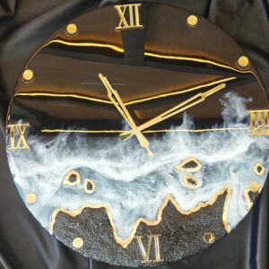 Handmade black and gold resin wall clock with ocean wave effect and Roman numeral design on glossy round face.