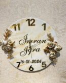 Personalized floral wall clock with custom names and date, featuring gold floral design and marble finish.